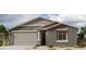 Beautiful single-Gathering home featuring a two-car garage, neutral color palette, and desert landscaping at 32661 N Newby Dr, San Tan Valley, AZ 85143