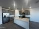 Modern kitchen featuring stainless steel appliances, gray cabinets, and a quartz island at 32661 N Newby Dr, San Tan Valley, AZ 85143