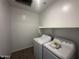 Efficient laundry room featuring a modern washer, dryer, and convenient shelving at 32661 N Newby Dr, San Tan Valley, AZ 85143