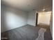 Spacious open living room and hallway with carpet and hard surface flooring at 32661 N Newby Dr, San Tan Valley, AZ 85143