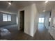 Hallway that opens to a living room, with hard surface floors and plush carpeting at 32661 N Newby Dr, San Tan Valley, AZ 85143