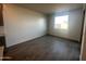 Bright, open living area with tile floors and a large window at 32661 N Newby Dr, San Tan Valley, AZ 85143