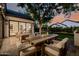 Cozy back patio with comfortable seating, a dining table, and a view of the lawn and surrounding greenery at 3301 E Elm St, Phoenix, AZ 85018