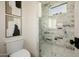 Modern bathroom with a glass-enclosed shower featuring marble-style tile and decorative artwork at 3301 E Elm St, Phoenix, AZ 85018
