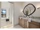 Elegant bathroom featuring double sinks, marble countertops, and modern fixtures with view of hallway at 3301 E Elm St, Phoenix, AZ 85018