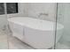 Modern, free-standing tub in a marble bathroom with a chrome faucet and a large window at 3301 E Elm St, Phoenix, AZ 85018