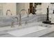 Close up of the double sink with marble counter tops and chrome fixtures at 3301 E Elm St, Phoenix, AZ 85018