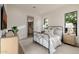 Bright bedroom with a metal frame bed, white bedding, and a view into an organized closet at 3301 E Elm St, Phoenix, AZ 85018