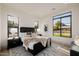 Well-lit bedroom with modern black frame windows, stylish furnishings, and neutral decor at 3301 E Elm St, Phoenix, AZ 85018