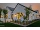 Exterior of modern home featuring manicured landscaping, stylish lighting, and lush lawn at 3301 E Elm St, Phoenix, AZ 85018