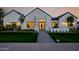 Striking modern home with a well-manicured lawn, walkway, and exterior lighting at 3301 E Elm St, Phoenix, AZ 85018