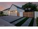 Charming home featuring an attached garage and stylish front yard with a paved driveway and wooden gate at 3301 E Elm St, Phoenix, AZ 85018