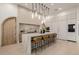 Modern kitchen with a large island, pendant lighting, and an arched wooden doorway at 3301 E Elm St, Phoenix, AZ 85018