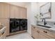 Well-equipped laundry room with modern washer/dryer and sleek countertop sink at 3301 E Elm St, Phoenix, AZ 85018