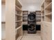 Well-organized laundry room featuring a stacked washer and dryer and ample storage space at 3301 E Elm St, Phoenix, AZ 85018