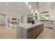 Open concept living and kitchen area with fireplace, shelving, and access to the backyard at 3301 E Elm St, Phoenix, AZ 85018