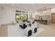 Bright open-concept living room with modern furnishings and glass doors to the backyard patio at 3301 E Elm St, Phoenix, AZ 85018