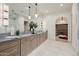 Well-lit primary bathroom with double vanities, arched doorways, and closet access at 3301 E Elm St, Phoenix, AZ 85018