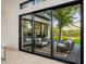 Outdoor patio seating area with lush landscaping seen through large glass doors at 3301 E Elm St, Phoenix, AZ 85018