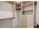 Organized walk-in closet featuring built-in shelving, drawers, and ample hanging space at 3301 E Elm St, Phoenix, AZ 85018