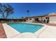 A refreshing in-ground pool with a covered patio, and neat landscaping with rocks at 3415 E Anderson Dr, Phoenix, AZ 85032