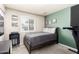Serene bedroom with green accent wall, natural light, records, and gray carpet flooring for a comfortable, stylish space at 3415 E Anderson Dr, Phoenix, AZ 85032