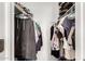 Walk-in closet offering ample storage with rods, shelving, and a diverse array of clothing for a neat and organized space at 3415 E Anderson Dr, Phoenix, AZ 85032