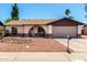Attractive single-story house showcasing a well-manicured front yard and a two-car garage at 3415 E Anderson Dr, Phoenix, AZ 85032