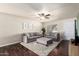 Cozy living room featuring stylish furnishings, hardwood floors, a ceiling fan, and neutral decor at 3415 E Anderson Dr, Phoenix, AZ 85032
