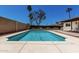 Refreshing in-ground pool surrounded by a concrete deck and privacy fence, perfect for outdoor enjoyment at 3415 E Anderson Dr, Phoenix, AZ 85032