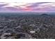 Dusk aerial view of a sprawling desert community with city lights and mountain views at 3648 N Sky Point Cir, Mesa, AZ 85207