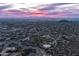 Dusk aerial view of a sprawling desert community with city lights and mountain views at 3648 N Sky Point Cir, Mesa, AZ 85207