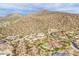 Desert homes nestled in the hills with pool, lush landscaping, and mountain backdrop at 3648 N Sky Point Cir, Mesa, AZ 85207