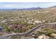 Desert community aerial showcasing winding roads, custom homes, and mountain vistas at 3648 N Sky Point Cir, Mesa, AZ 85207