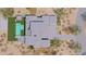Aerial view of modern home with an outdoor kitchen, pool, and entertainment space at 3648 N Sky Point Cir, Mesa, AZ 85207
