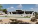 Beautiful exterior elevation of the home with a swimming pool and desert landscaping at 3648 N Sky Point Cir, Mesa, AZ 85207