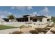 Rear exterior showcasing an outdoor living space, pool, balcony, and beautiful desert landscaping at 3648 N Sky Point Cir, Mesa, AZ 85207