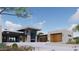 Contemporary home boasts clean lines, stone accents, a flat roof and wood garage doors, complemented by desert landscaping at 3648 N Sky Point Cir, Mesa, AZ 85207