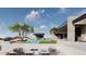 Modern home boasts a sparkling pool, covered outdoor kitchen, and desert views perfect for relaxation at 3648 N Sky Point Cir, Mesa, AZ 85207