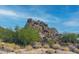 View of a rocky hill with boulders and native desert plants under a sunny blue sky at 3648 N Sky Point Cir, Mesa, AZ 85207