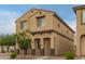 A two-story home features a covered porch and neutral stucco, complemented by simple desert landscaping at 3713 S 54Th Ln, Phoenix, AZ 85043