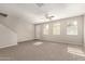 Spacious living room with natural light, carpeted floors and a view of the front door at 3713 S 54Th Ln, Phoenix, AZ 85043