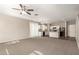 Living room that flows into a kitchen with carpeted floor, a ceiling fan and neutral wall color at 3713 S 54Th Ln, Phoenix, AZ 85043