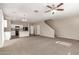 Open living area with a ceiling fan, open staircase and view of the kitchen and dining area at 3713 S 54Th Ln, Phoenix, AZ 85043