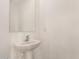 Pedestal sink and mirror in half bath at 3713 S 54Th Ln, Phoenix, AZ 85043