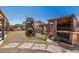 Spacious backyard featuring a playset and outdoor pet enclosure, ready for recreation at 4207 W Soft Wind Dr, Glendale, AZ 85310