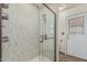 Bathroom featuring a glass enclosed shower and back door access at 4207 W Soft Wind Dr, Glendale, AZ 85310