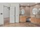 Bathroom features dual sink vanity with granite counters and an adjacent door to a bedroom at 4207 W Soft Wind Dr, Glendale, AZ 85310