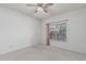 Bright bedroom with a ceiling fan, carpeted floors, and a window providing natural light at 4207 W Soft Wind Dr, Glendale, AZ 85310