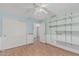 Bedroom with wood floors, a closet, and built-in shelving at 4207 W Soft Wind Dr, Glendale, AZ 85310
